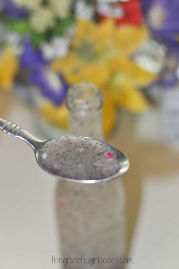 A photo of a spoonful of poppyseed salad dressing.