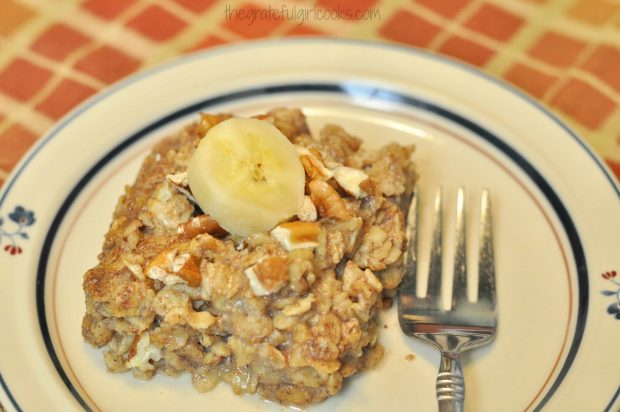 Piece of baked banana bread oatmeal on plate with a fork