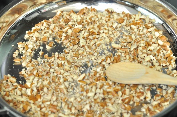 Dry toasting chopped pecans in skillet, for decorating Edie's carrot cake.
