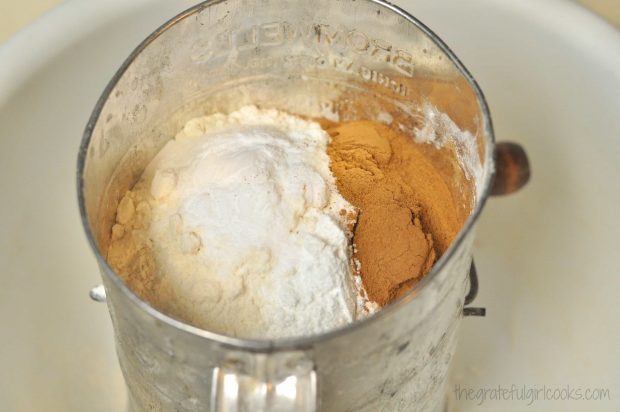 Flour, cinnamon and spices for Edie's carrot cake, cake in sifter.