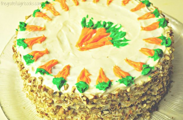 Edie's carrot cake, with frosting and toasted pecans decorating it.