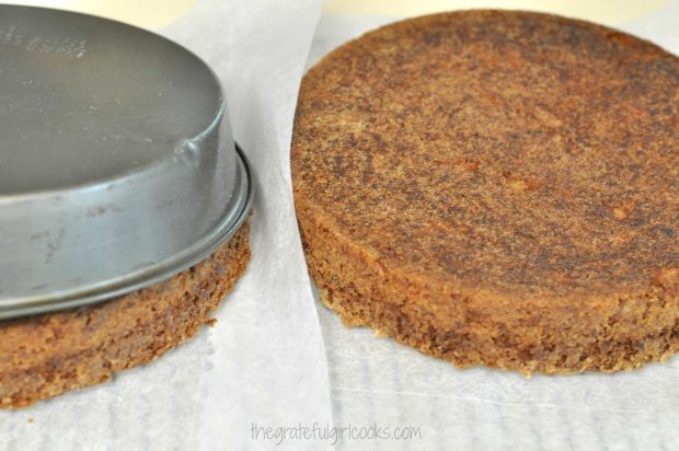 Edie's carrot cake is inverted onto parchment paper on rack to release it from pan.