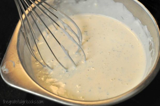 Creamy salad dressing is mixed for chicken club pasta salad