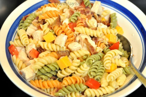 Pasta, bacon, tomatoes and cheese are mixed together for club salad