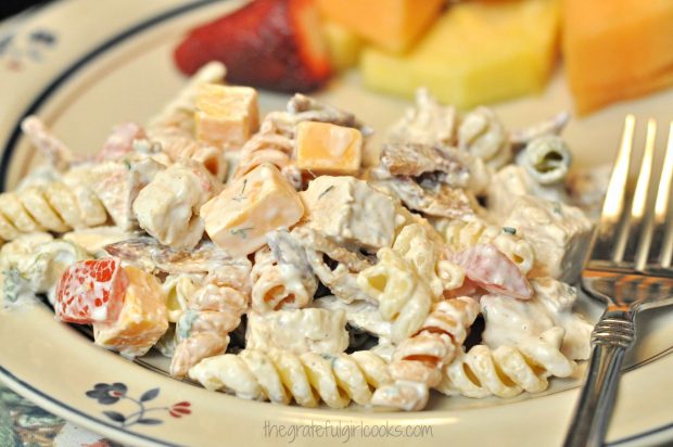 Chicken club pasta salad, on plate with fresh fruit