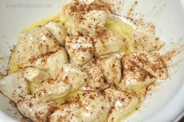 Buttered monkey bread minis are liberally sprinkled with cinnamon.