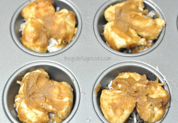 More dough and butter brown sugar topping is added to monkey bread minis in muffin tins.