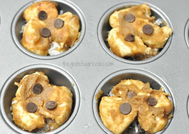 A few chocolate chips are added to tops of monkey bread minis.