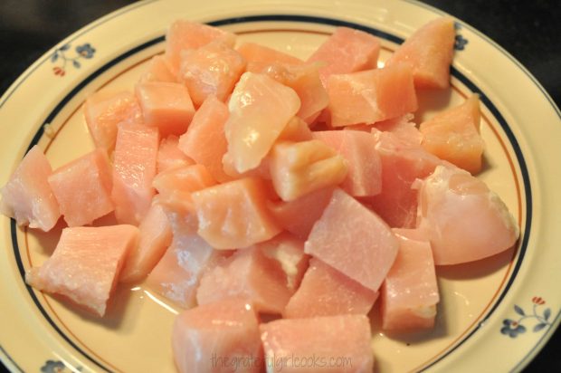 Chicken breasts cut into cubes for cashew chicken.