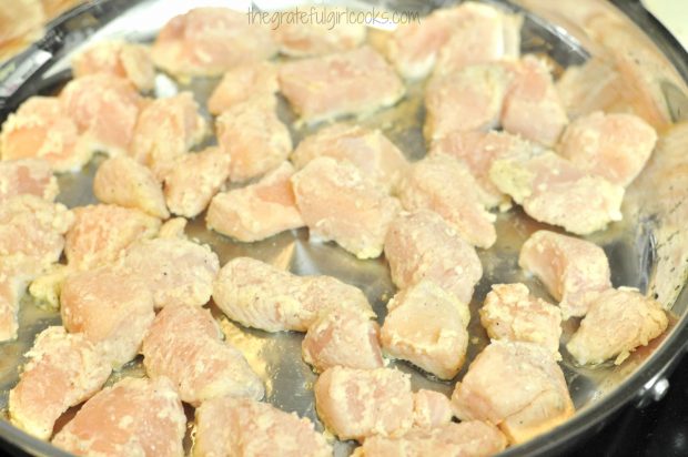 Chicken pieces are cooked in very hot oil until browned.