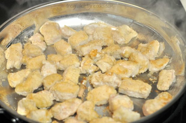 Cooked chicken is turned over so the other side is cooked until golden brown.