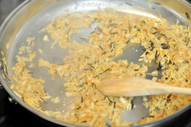 Chopped onions are cooked with orzo and wild rice for homemade rice pilaf.