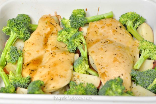 Chicken with broccoli and potatoes in white baking pan
