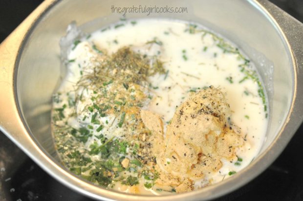 Mixing the ingredients to make homemade ranch dressing for salads.