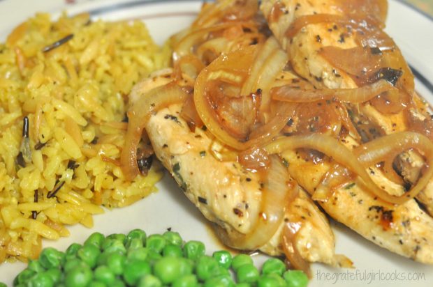Homemade rice pilaf, served with peas and chicken.