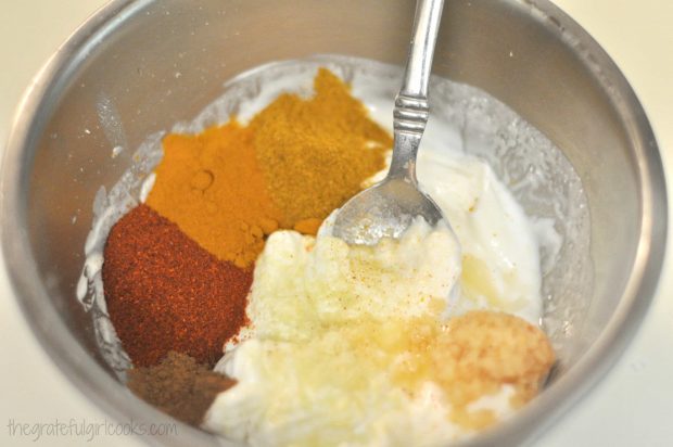 The tandoori spices for the chicken are mixed with plain yogurt in a small bowl.