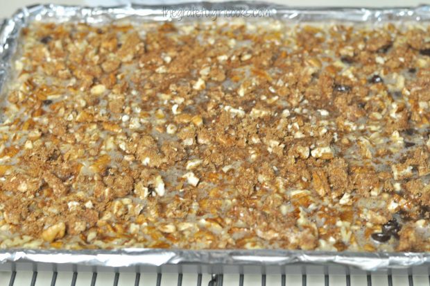 Crumbly topping is added to the top of the chocolate pecan pie bars in pan before baking.