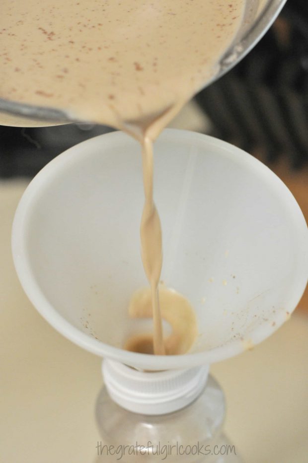 Pouring the creamer through a funnel into bottle.