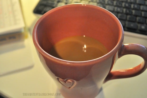Cup of coffee with cinnamon roll coffee creamer