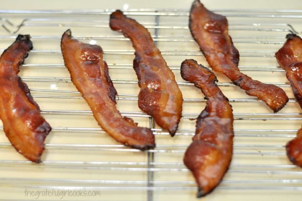 The bacon cools on a wire rack.