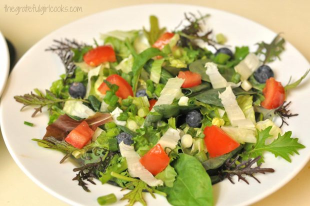 Green salad is reading to be topped with homemade ranch dressing.