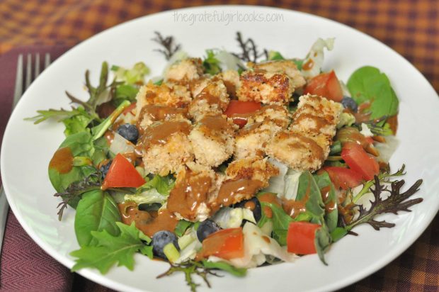Mixed Salad with Hoisin Vinaigrette and Crisp Panko Chicken is served in a white bowl.