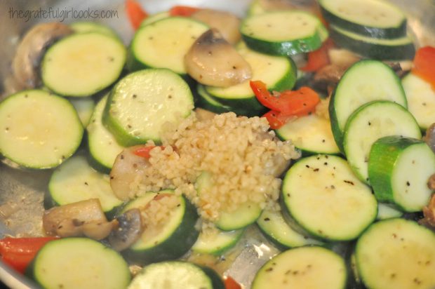 Minced garlic, and spices are added to the skillet zucchini.