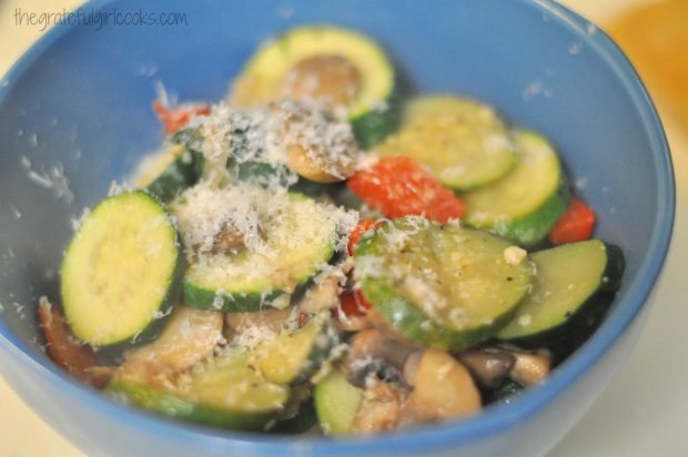 Finely grated Parmesan cheese is sprinkled over the skillet zucchini before serving.