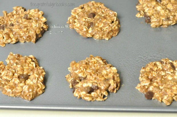 Dough for oatmeal chocolate chip cookies, on baking sheet.