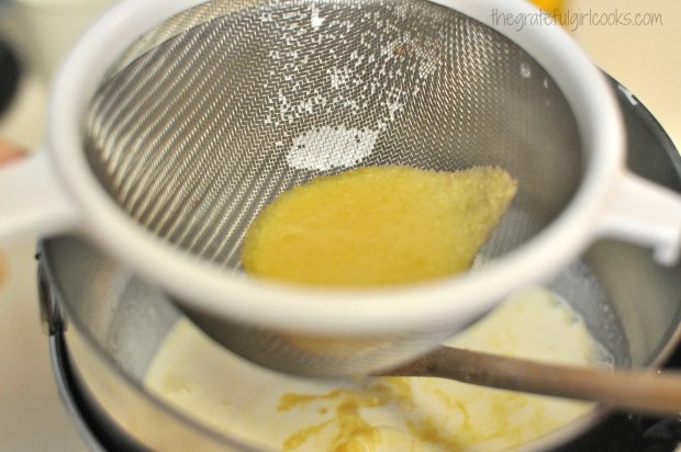 Straining ice cream base liquid into bowl