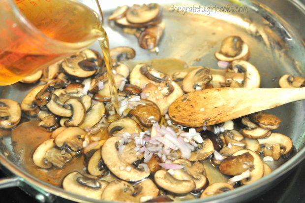 Chopped shallots, garlic and Marsala wine are added to the cooked mushrooms in the skillet.