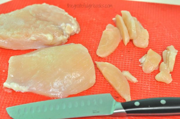 Chicken breasts are thinly sliced before being seasoned.