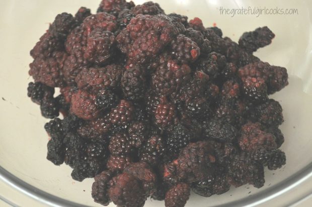 Fresh boysenberries are rinsed then drained.