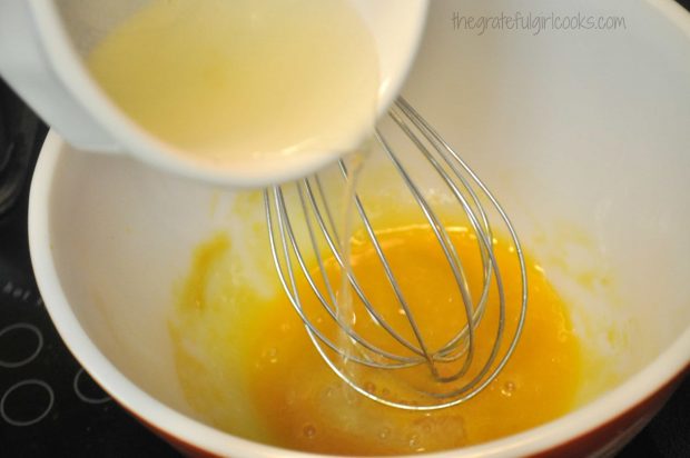 Vinegar and lemon juice is whisked into egg mixture for mayonnaise