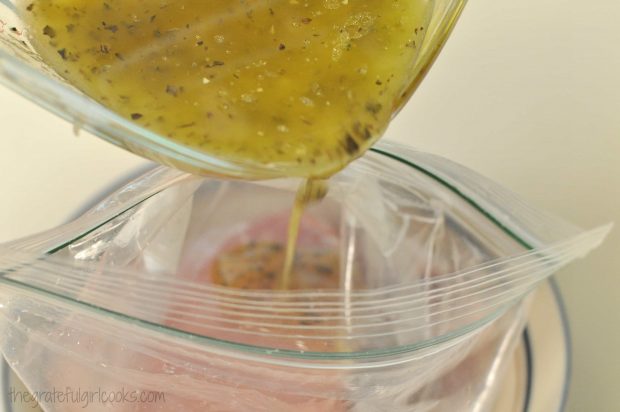 Lemon marinade is poured over pork chops in resealable bag.