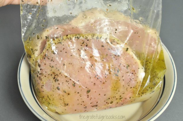 Pork chops marinade in sauce in refrigerator for a couple hours.