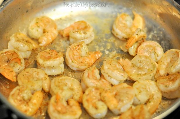 The seasoned shrimp are pan-seared in olive oil.