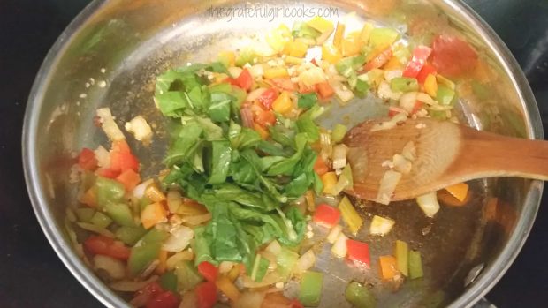 Swiss chard, bell peppers and onions are cooked before adding to the dish.