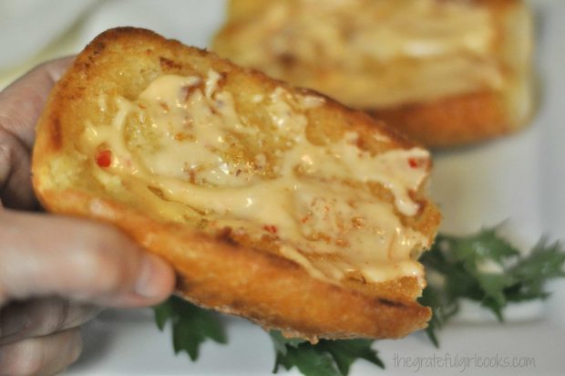 Chili mayo is spread on toasted french rolls for sandwich