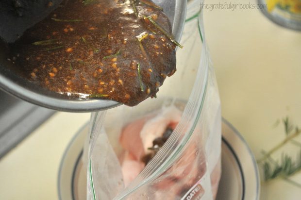 Marinade being poured into plastic bag over pork