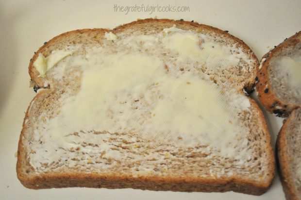 Bread is buttered on one side before grilling the "Elvis Special" sandwich.