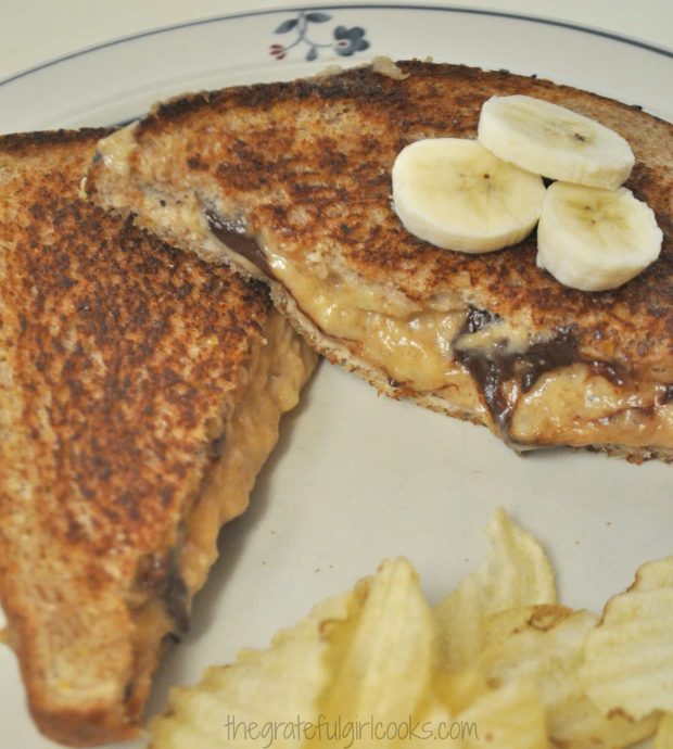 Grilled "Elvis Special" Sandwich is sliced in half, and topped with sliced bananas to serve.