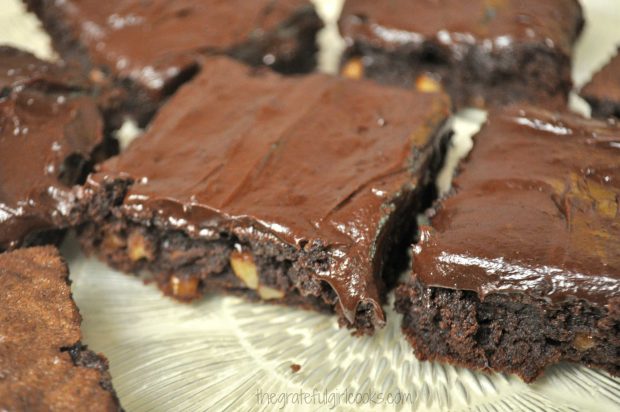 JB's Best Brownies, with frosting, on a clear platter.