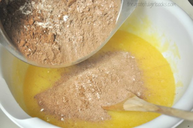 Flour, cocoa, and other dry ingredients are added to the batter.