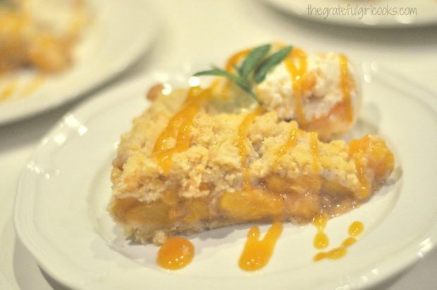 Peach Shortbread Tart served with peach coulis drizzle and ice cream.