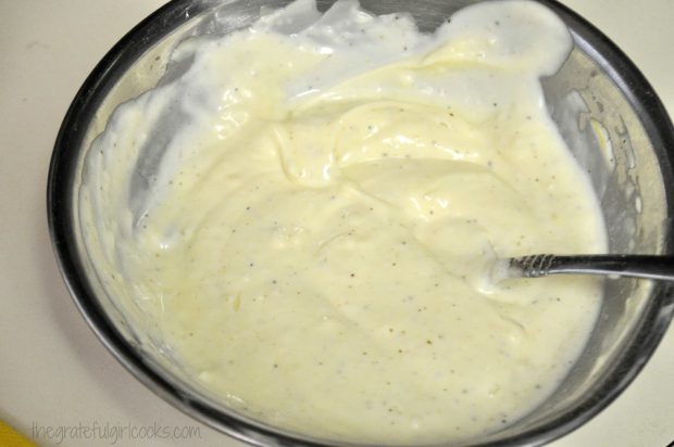 Potato salad dressing is mixed together in metal bowl.