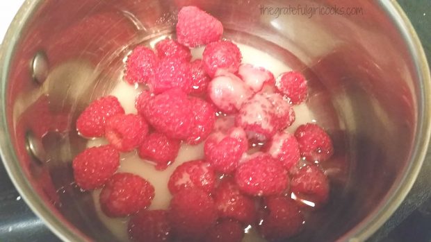 Whole raspberries, water and sugar in a pan, ready to cook!