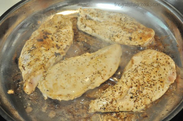 Chicken breasts are cooked and browned on both sides for skillet Monterey chicken.