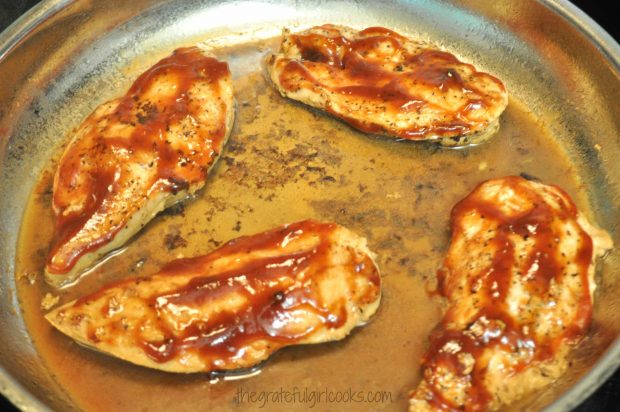 BBQ sauce is spread over each piece of Skillet Monterey Chicken.