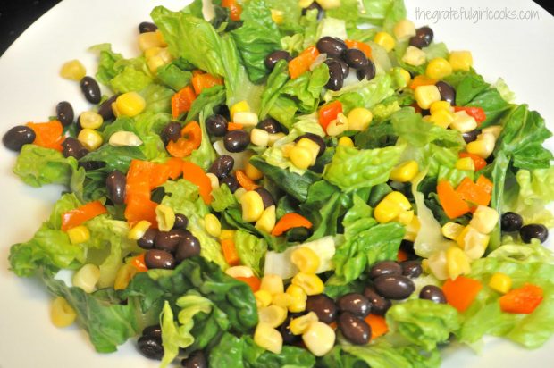 Romaine lettuce, corn, beans and orange bell peppers are the foundation for the salad.